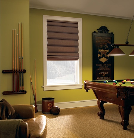 Roman shades in Denver game room with green walls.
